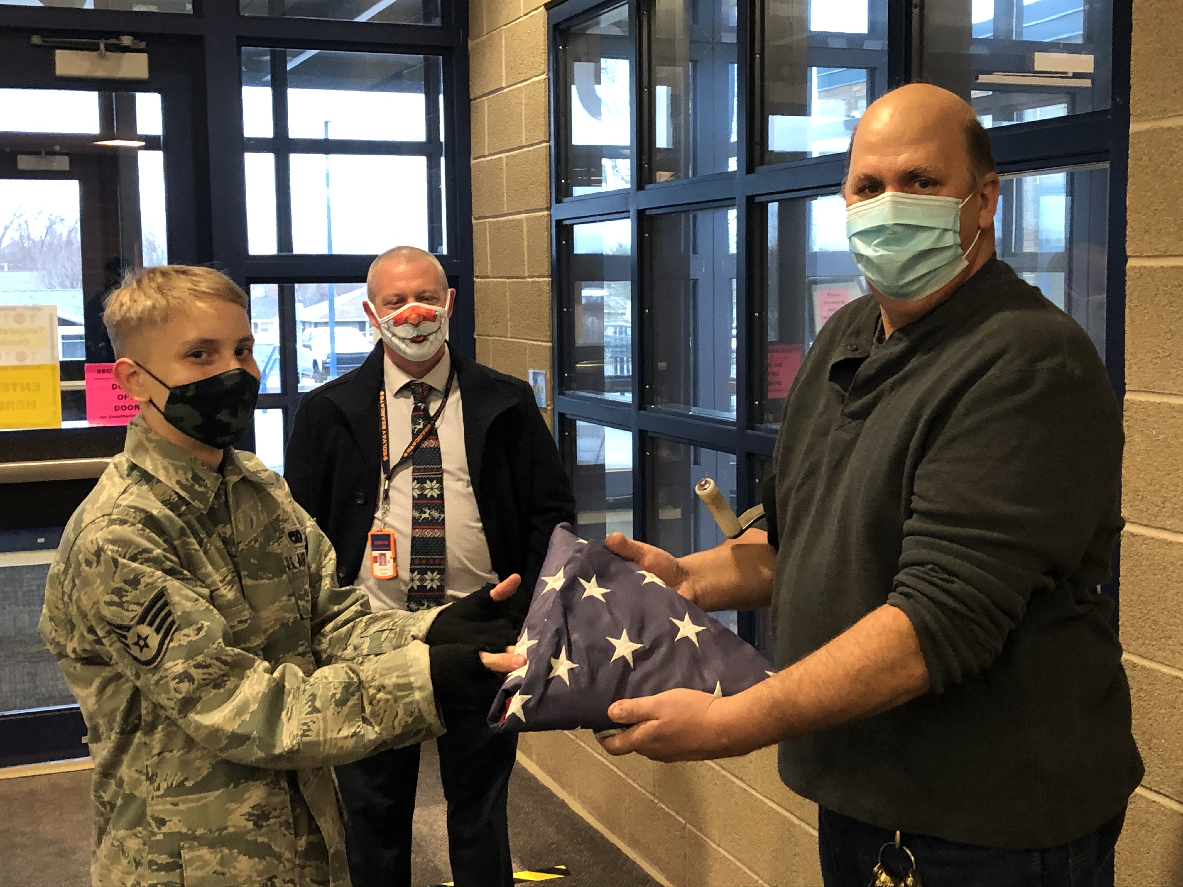 Nathan presenting the flag to Mr. Fisher & Mr. Graves