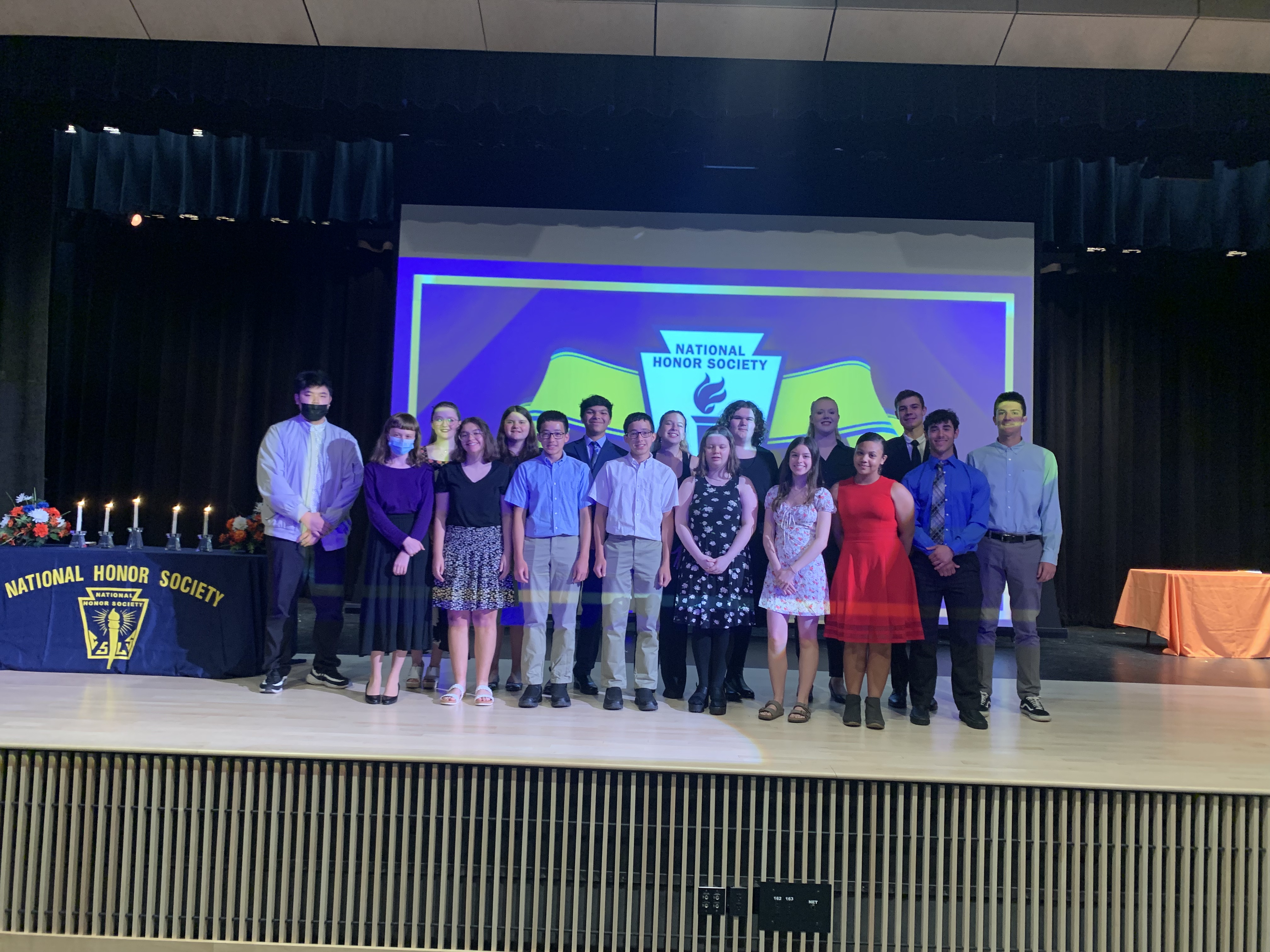 National Honor Society students pose for pictures on stage at Solvay High school