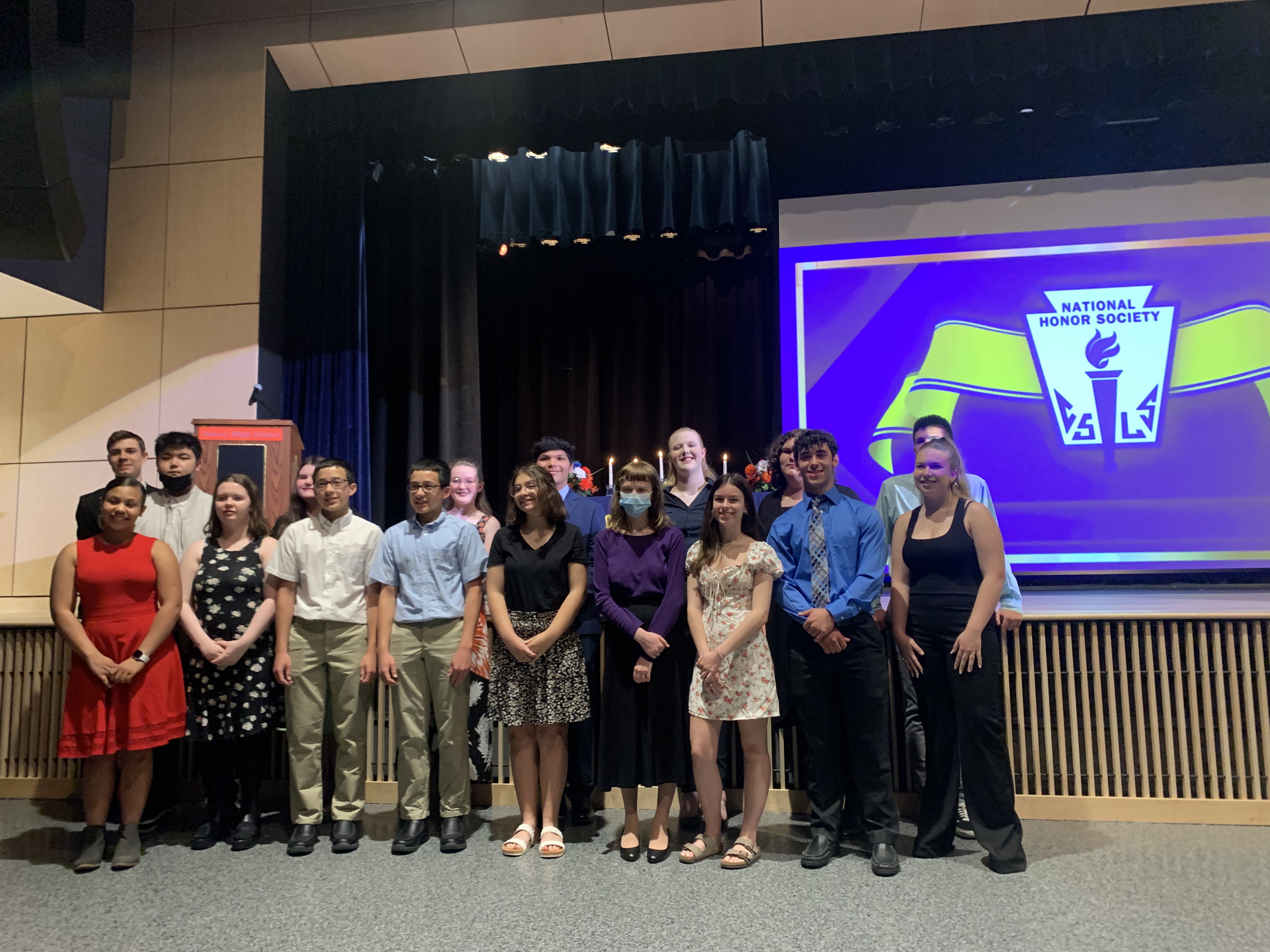 National Honor Society students pose for pictures on stage at Solvay High school