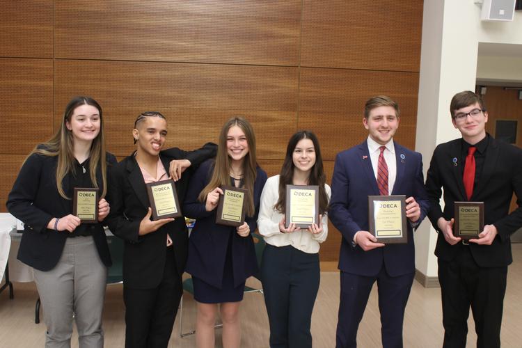 Senior award winners with plaques