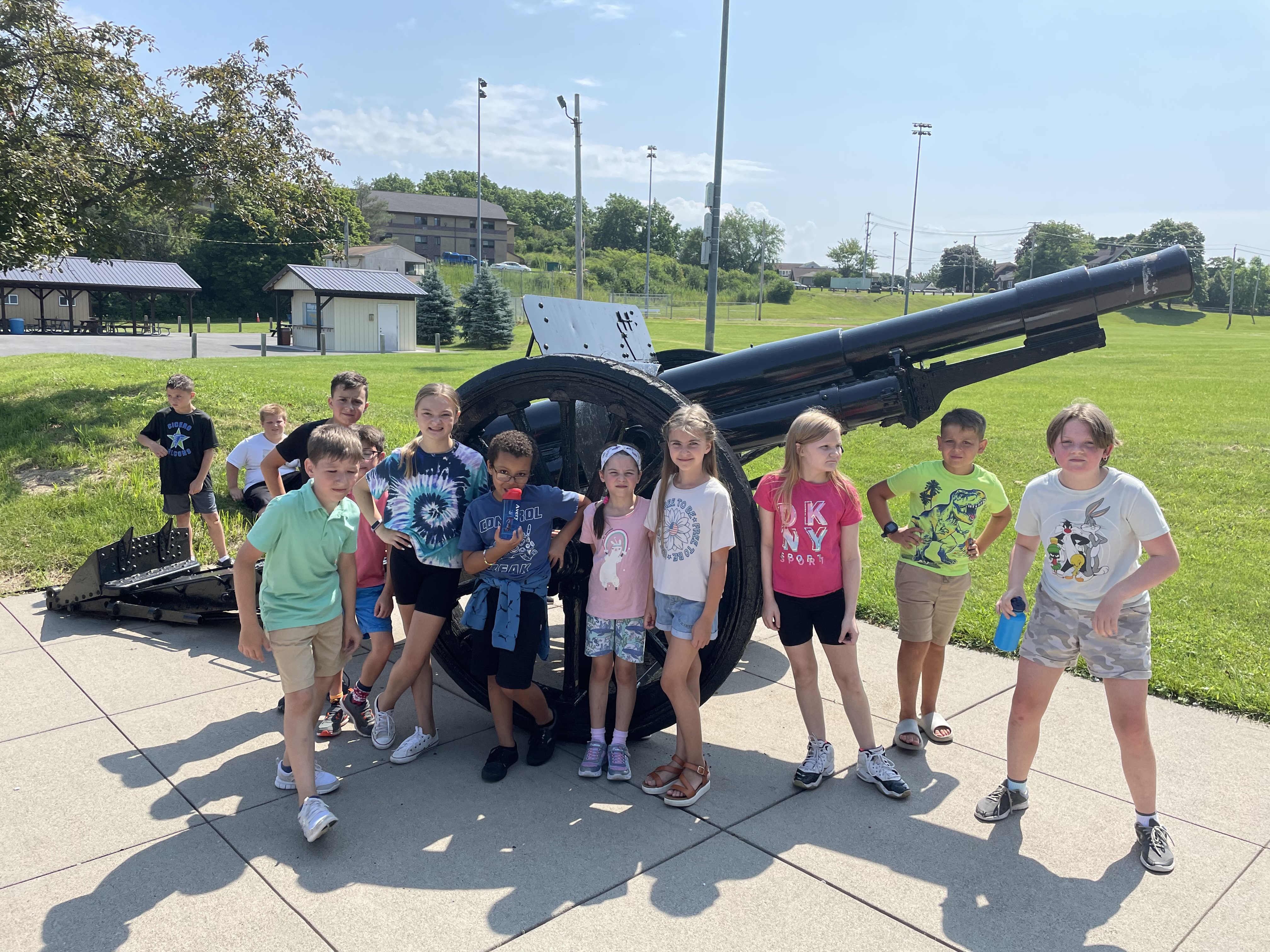 summer program students pose near a cannon