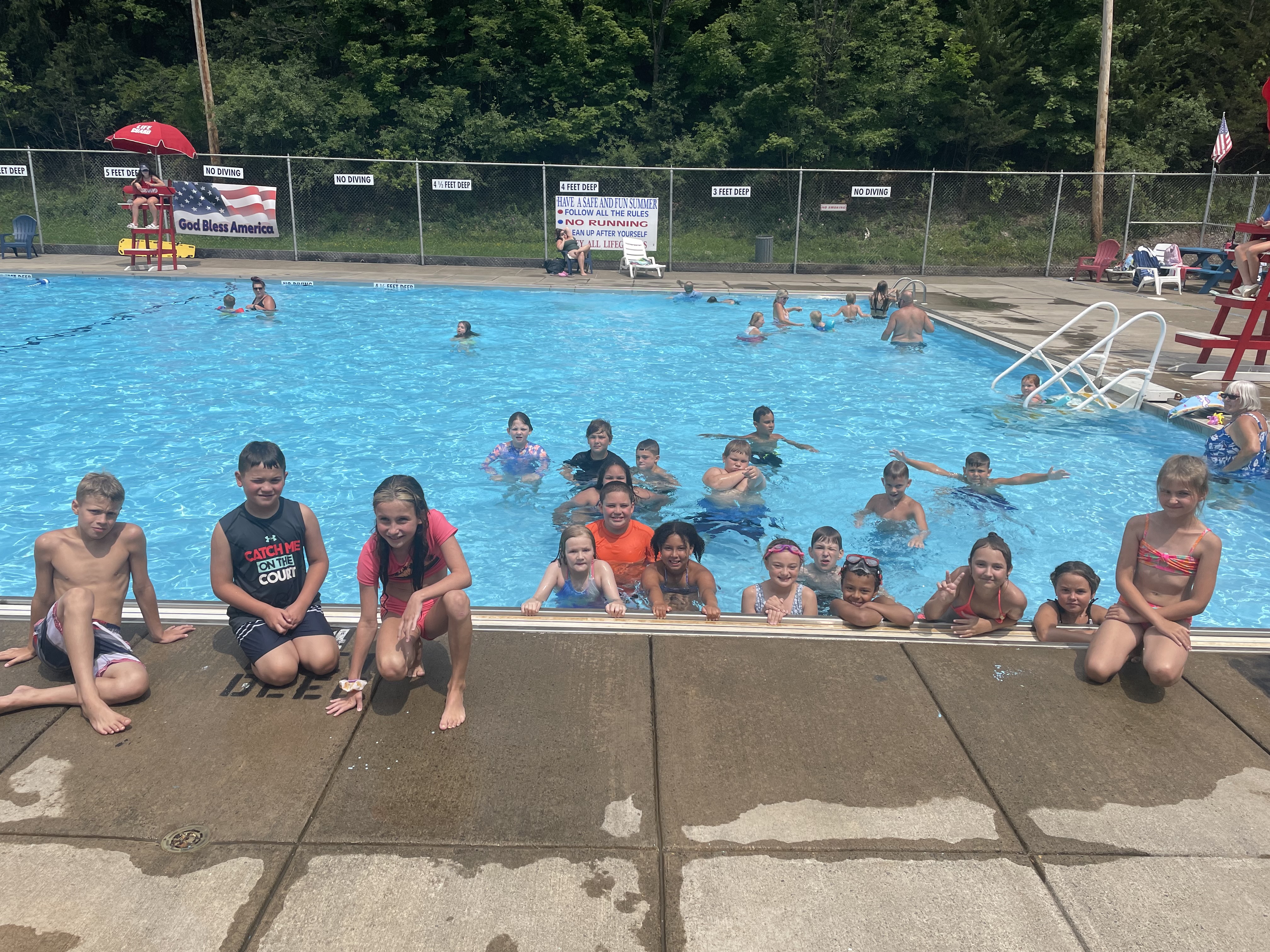summer program students pose at the pool