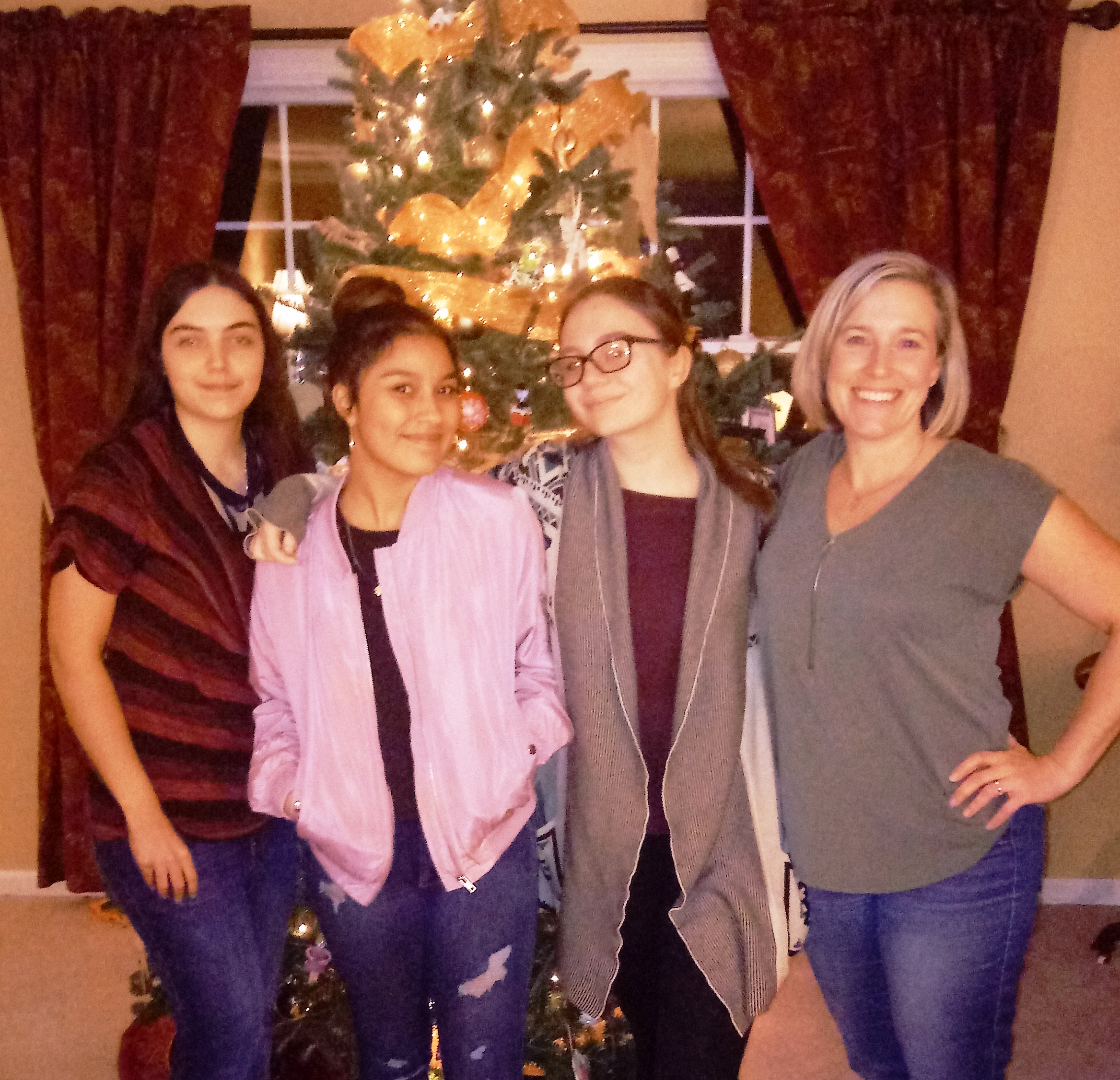 Two students and 1 teacher pose for a photograph about vegetarian cooking.