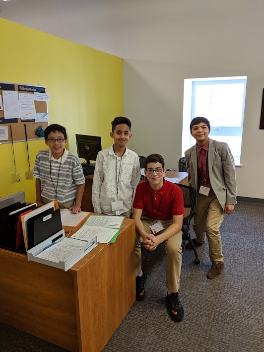 students sit behind the desks